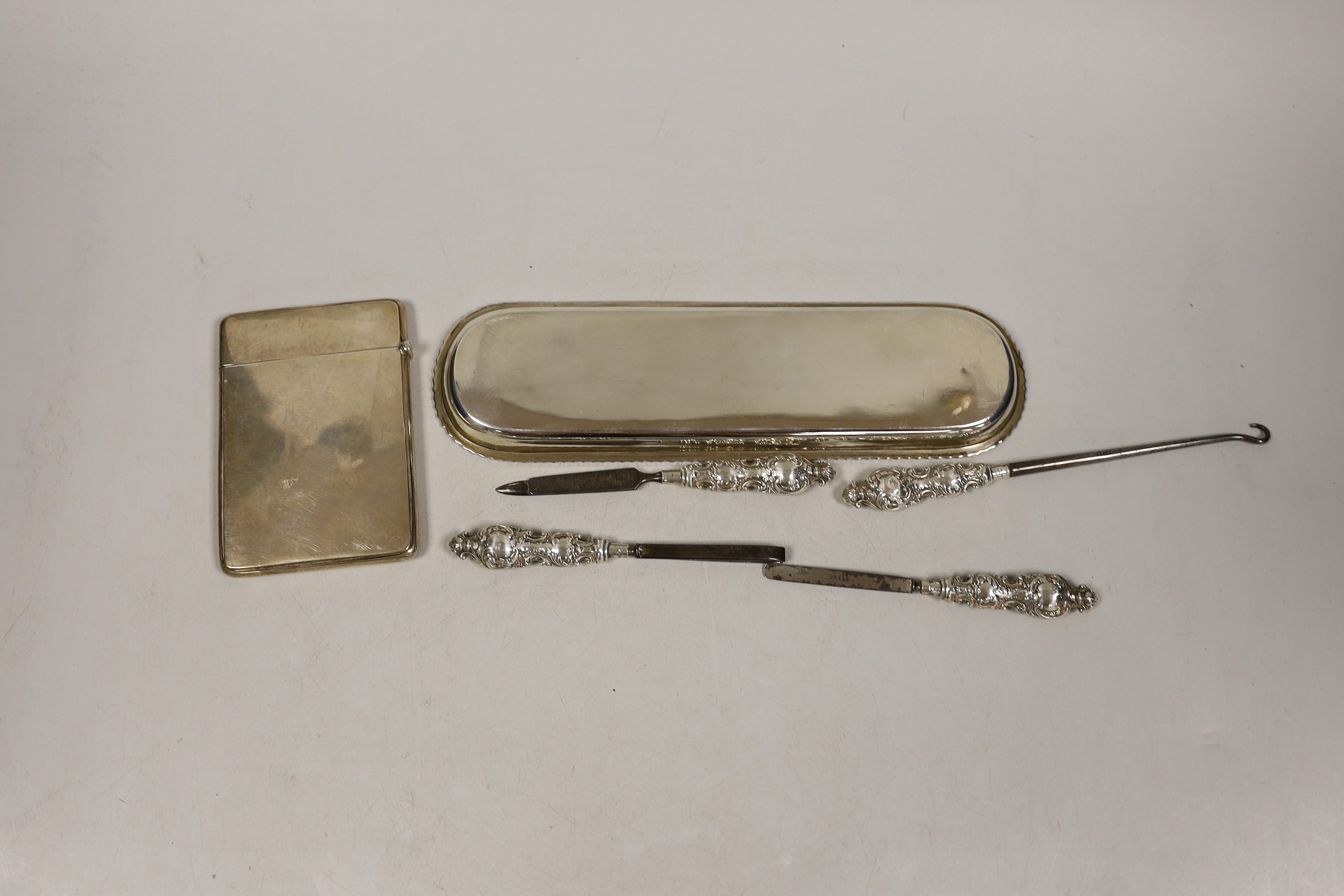 A George V engraved silver card case, by Crisford & Norris, a silver pen tray and four manicure tools.